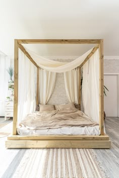 a bed with white drapes on top of it