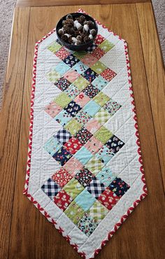 a table runner with a bowl of flowers on it