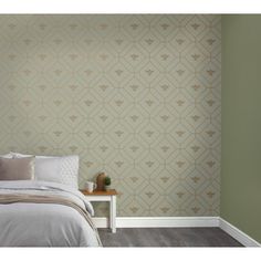 a bed sitting in a bedroom next to a wall with a pattern on the wall