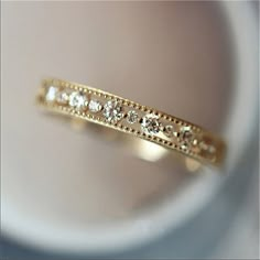 a close up view of a gold ring with diamonds