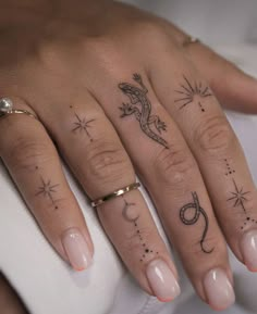 a woman's hand with two tattoos on it