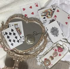 a table topped with lots of cards and jewelry