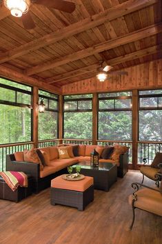 a living room with lots of furniture and wood flooring on the inside of it