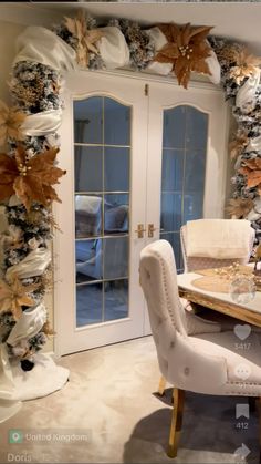 the dining room table is set for two with white chairs and gold leaves on it