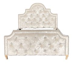 a white bed with an ornate headboard and foot board on top of the frame