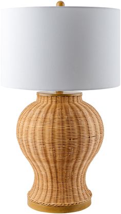 a wicker lamp with a white shade on it