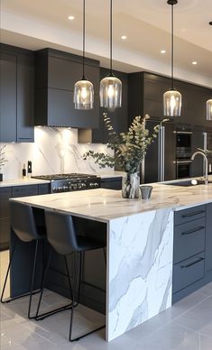 a large kitchen with marble counter tops and black chairs in front of an island that has three pendant lights hanging from the ceiling