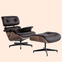 an eames lounge chair and ottoman with black leather upholstered on the back