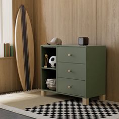 a green cabinet sitting next to a black and white rug