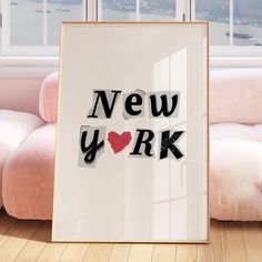 a new york framed in front of a window with the word love written on it