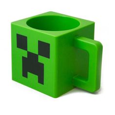 a green minecraft coffee cup holder with a black face on it's side