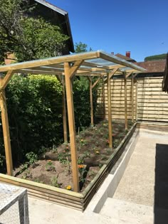 an outdoor garden area with wooden structures and plants