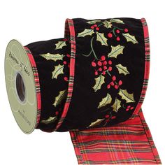 a roll of christmas ribbon with holly and berries on it