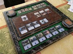 a game board sitting on top of a table covered in cards and magnets,