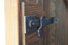 a close up of a wooden door with a metal handle on the front and side