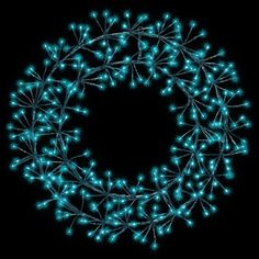 a christmas wreath with blue lights in the shape of a circle on a black background