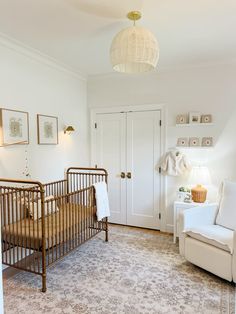 a baby's room with a crib and chair