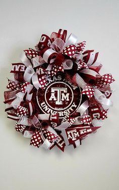 the texas a & m university wreath is made out of red and white ribbon with polka dots