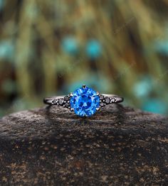 a blue ring sitting on top of a rock