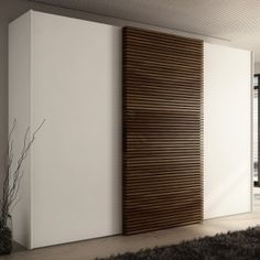 a modern living room with white walls and wood slats on the sliding glass doors