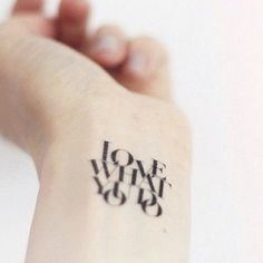 a person's arm with a tattoo that says love and joy on it,