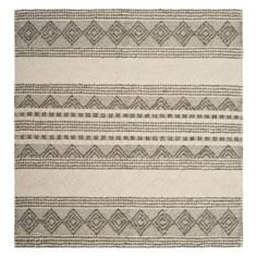 an area rug with grey and white designs on it, in front of a white background