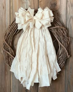 a wreath with a bow hanging on a wooden wall