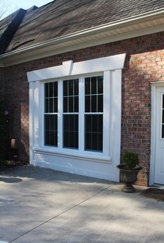 a brick house with white doors and windows