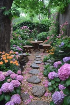 a garden with flowers and rocks in the middle