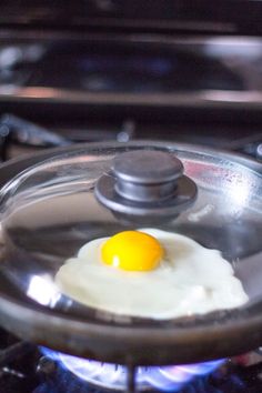 an egg frying in a skillet on the stove