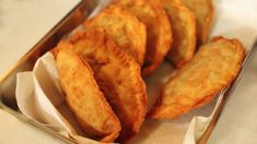 some fried food in a metal container on a counter