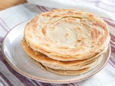 a stack of pancakes sitting on top of a white plate