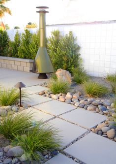 a garden with rocks and plants around it