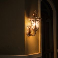 a light that is on the side of a wall next to a door and window