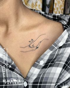 a woman with a small tattoo on her chest