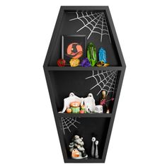 a black shelf with halloween decorations on it