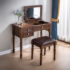 a dressing table with a mirror and stool