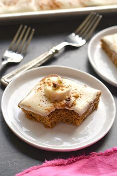 two white plates topped with slices of cake