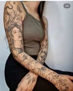 a woman with tattoos on her arm sitting down