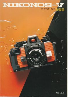 an image of a camera on the cover of a book with water drops around it