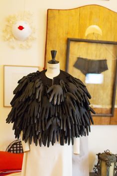 a mannequin with black feathers on it