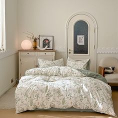 a bedroom with a bed and dresser in it