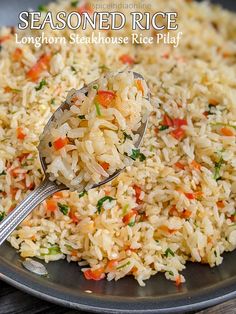 a spoon full of rice on top of a plate