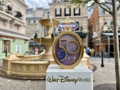 the 50th anniversary sign is on display in front of disney world's main street