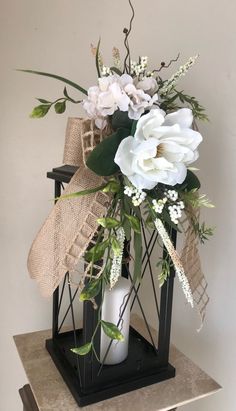 a vase filled with white flowers on top of a table