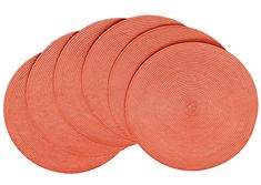 six orange round placemats are stacked on top of each other