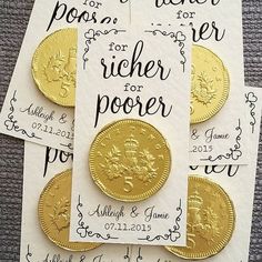 some gold coins are sitting on top of white paper with black ink and calligraphy