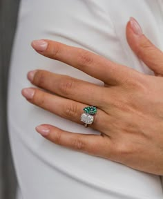 a close up of a person's hand with a ring on it