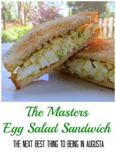 an egg salad sandwich cut in half on a white plate with the words, the masters egg salad sandwich