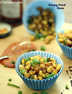 three blue cups filled with food sitting on top of a table